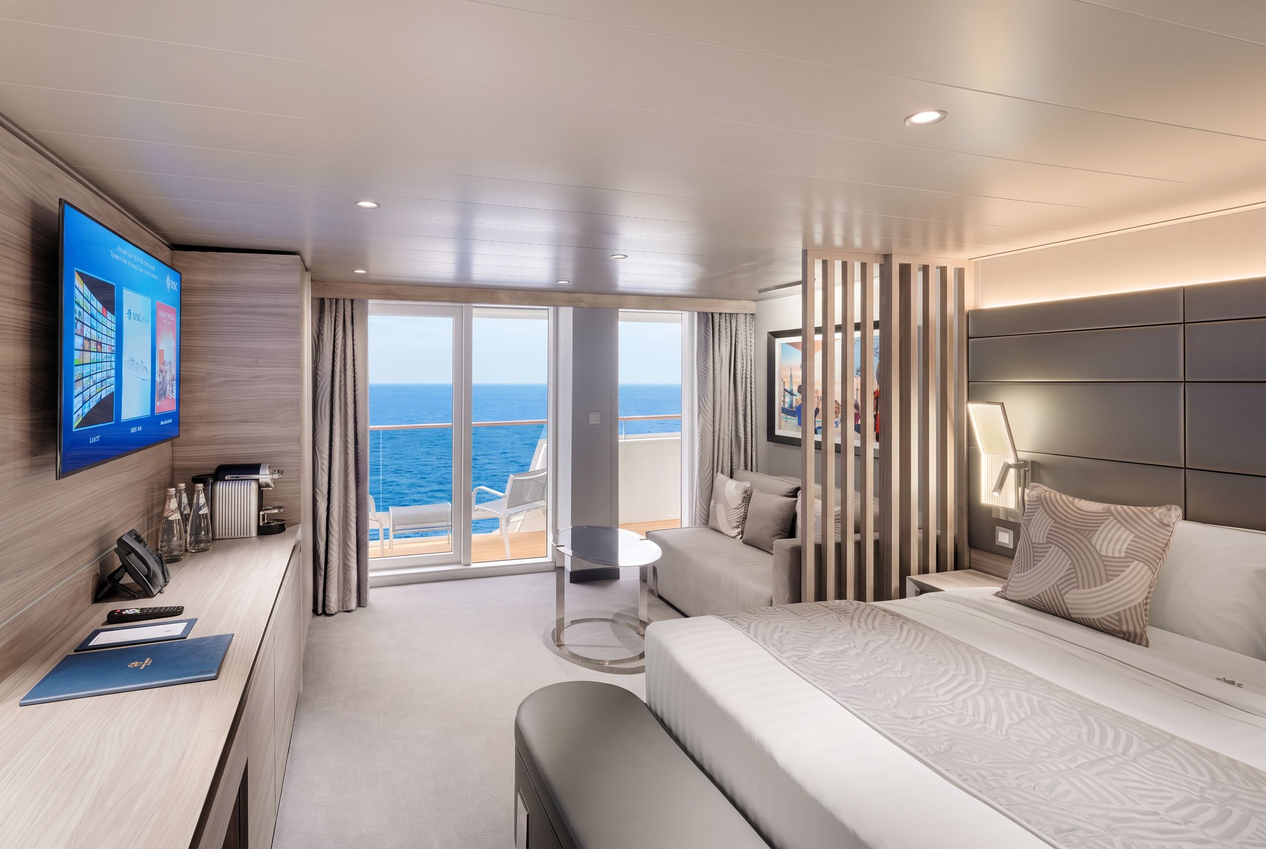 MSC Yacht Club balcony suite with a sitting area and ocean view